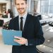 Confident car salesman with clipboard in a modern dealership showroom